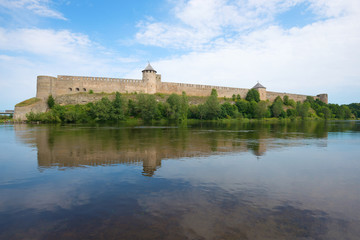 Fototapeta na wymiar Ivangorod fortress on the Narva river on a cloudy August day. Russia