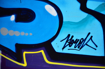 The old wall, painted in color graffiti drawing blue aerosol paints. Background image on the theme of drawing graffiti and street art
