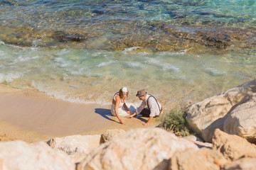 Bride and groom by the sea on their wedding day.