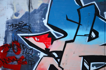 The old wall, painted in color graffiti drawing blue aerosol paints. Background image on the theme of drawing graffiti and street art