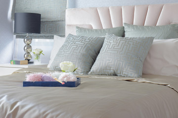 Knitting tray and flower on bed in satin finished bedding style