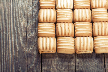 Sweet cookies on wooden background