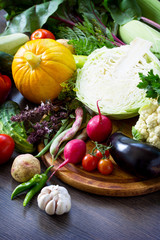 Fresh mixed different vegetables on a wooden oak background. Food background. The concept of a healthy diet. Copy space.