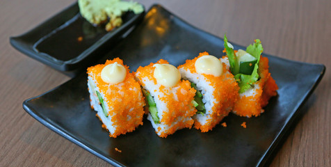 sushi in black square plate.
