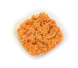 Sweet crispy noodles packed in plastic box isolated on white background.