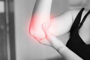 elbow pain. Women holds hand on his pain elbow, sport physical injuries when working out.