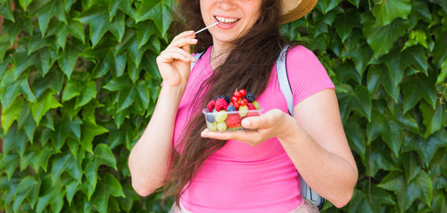 healthy eating, dieting, vegetarian food and people concept - close up of woman hands holding berries outdoor