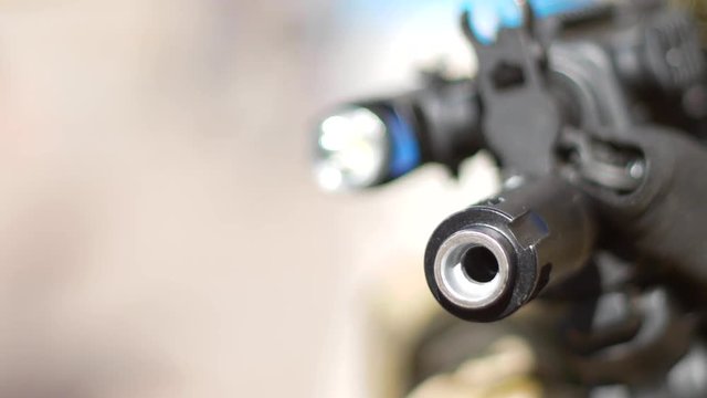 Barrel of submachine gun in the hands of peacemaker
