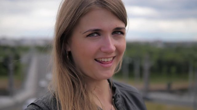 Portrait of a cheerful cute sexy young female blonde who shows tongue, close-up.