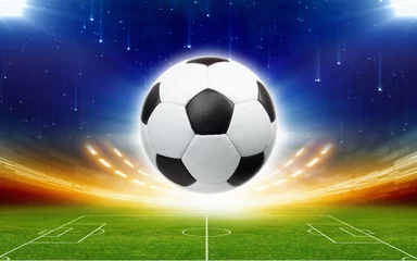 Poster Soccer Soccer ball above green football stadium at night