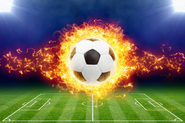 Burning soccer ball above green football stadium