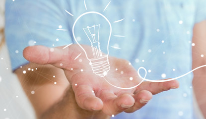 Businessman holding a sketch lightbulb