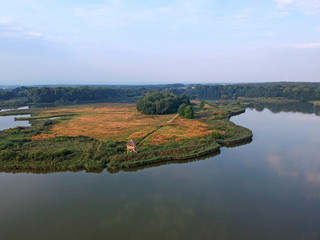 Naklejka premium Beautiful summer morning landscape with lake, forest and birdwatching tower from airplane in central Europe - Czechia