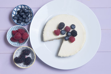Vanilla cheesecake topped with blueberries, blackberries and raspberries