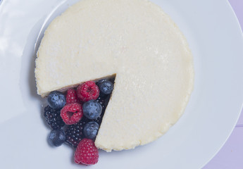Vanilla cheesecake with blueberries, blackberries and raspberries