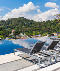 Sunbeds near swimming pool on the top roof
