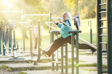 Obraz na płótnie Canvas Senior Woman doing Exercises Outdoors