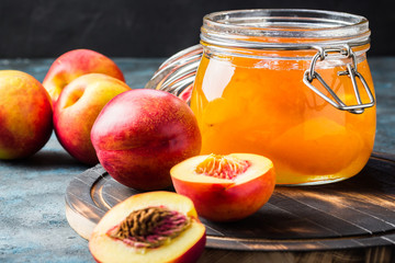 Golden plums and a jar with low sugar plum jam.  Selective focus, space for text.