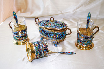 Antique handmade Persian Enamel Gold Tea Set consisting of a Sugar cube holder long Tea spoons and...
