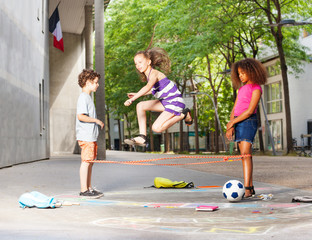 Group of kids play Chinese jump rope game