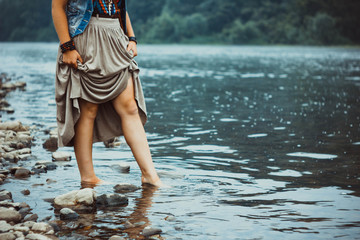 Fototapeta premium feet of a woman in a river