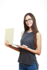 Portrait of happy smiling young business woman in glasses isolated over white background holds a laptop in her hands