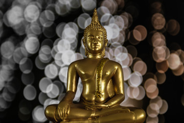 Amazing golden buddha with bokeh background, symbol of peace, meditation and  enlightenment