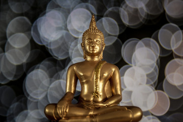 Amazing golden buddha with bokeh background, symbol of peace, meditation and  enlightenment