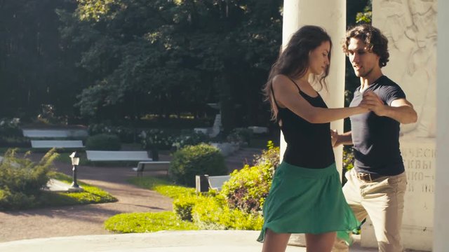 Young couple dancing in the park