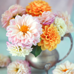 Beautiful bouquet of a yellow and pink dahlias on a light green background.Lovely bunch of flowers . 