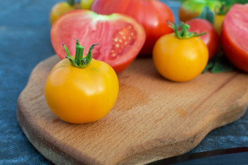 Yellow and red tomatoes on the board