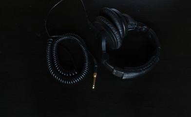 black headphones on the black background