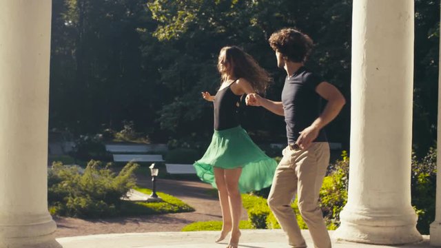 Young couple dancing in the park