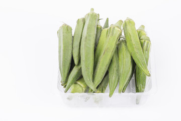 Fresh young okra In a box and on white background.