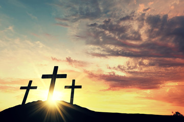 Religious cross silhouette against a bight sunrise sky. 3D Rendering - obrazy, fototapety, plakaty