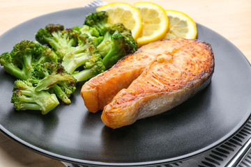 Delicious roasted salmon steak with vegetable on plate