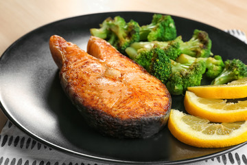 Delicious roasted salmon steak with vegetable on plate