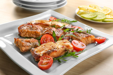 Delicious roasted salmon fillets with vegetable on plate