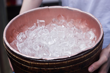 Male holding container with ice cubes
