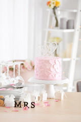 Beautiful composition with tableware, cake and decor for lesbian wedding