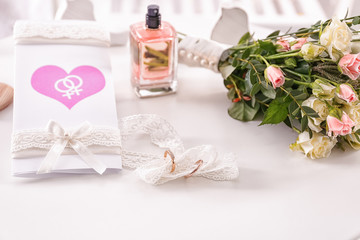 Obraz na płótnie Canvas Invitation card and rings for lesbian wedding on table