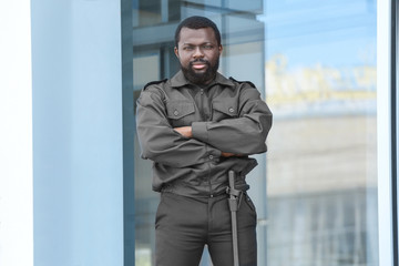Male security guard near big modern building