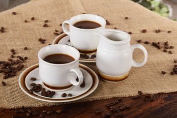 cups of coffee and milk and roasted coffee beans