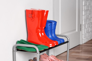 Different shoes on shelf near wall