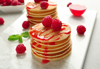 Delicious pancakes with raspberries on board