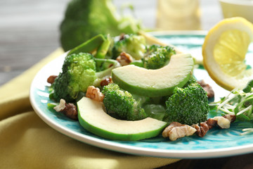 Plate with broccoli salad on table