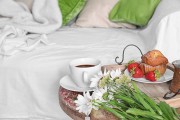 Light breakfast on the table near the bed