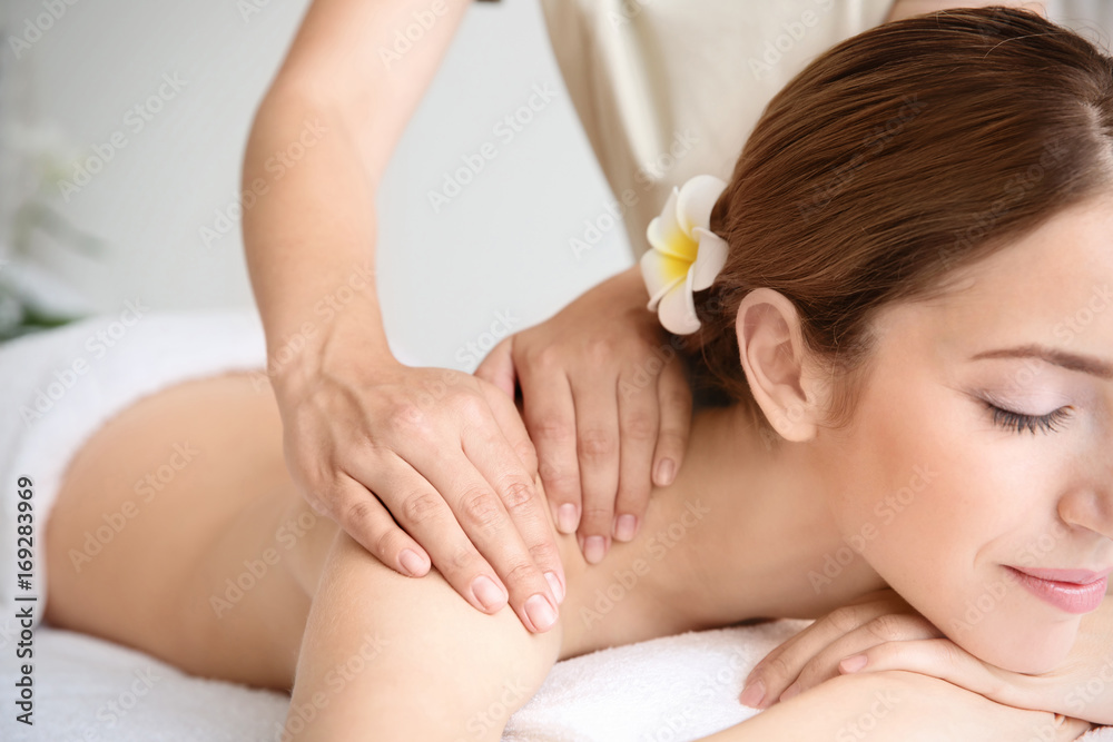 Poster Young beautiful woman having massage in spa salon