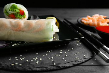 Portion of spring rolls on slate plate