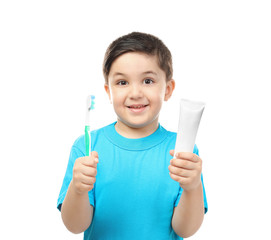 Cute boy with toothbrush and paste on white background. Teeth cleaning concept